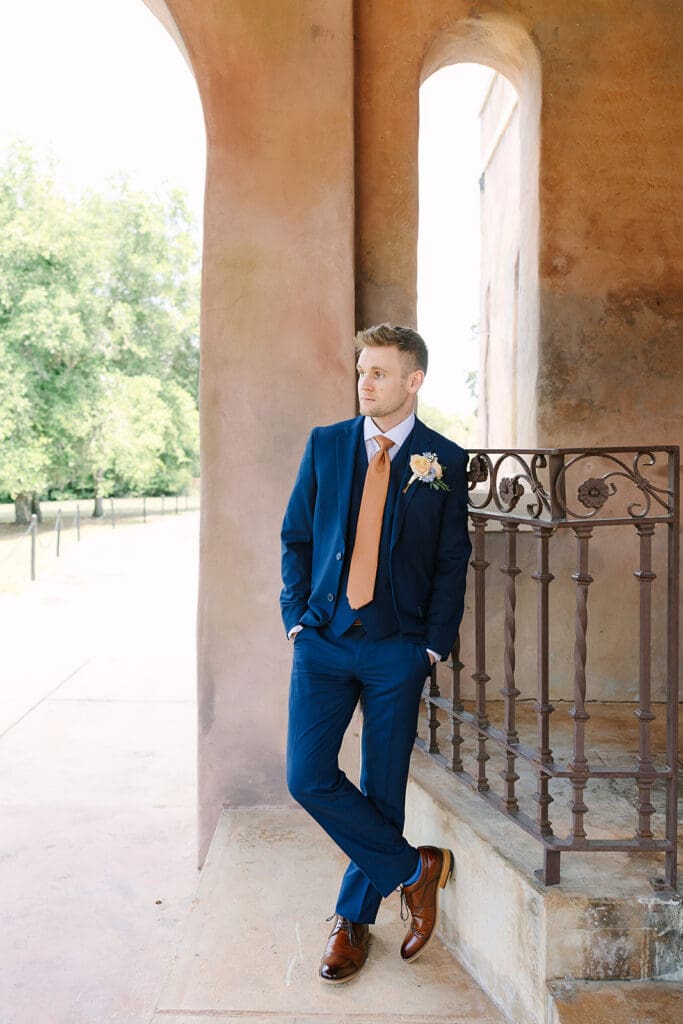 groom in a blue suit portrait at The Howey Mansion captured by Jennifer Holly Photography