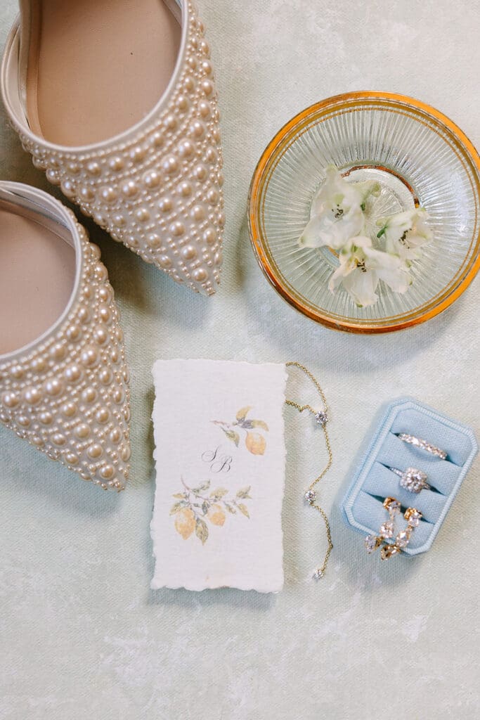 dusty blue and peach wedding details flat lay at a wedding at The Howey Mansion captured by Jennifer Holly Photography