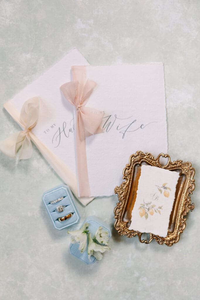 dusty blue and peach wedding details flat lay at a wedding at The Howey Mansion captured by Jennifer Holly Photography