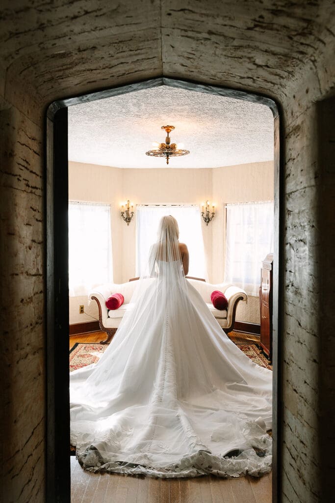 bride portrait through a doorway at The Howey Mansion captured by Jennifer Holly Photography