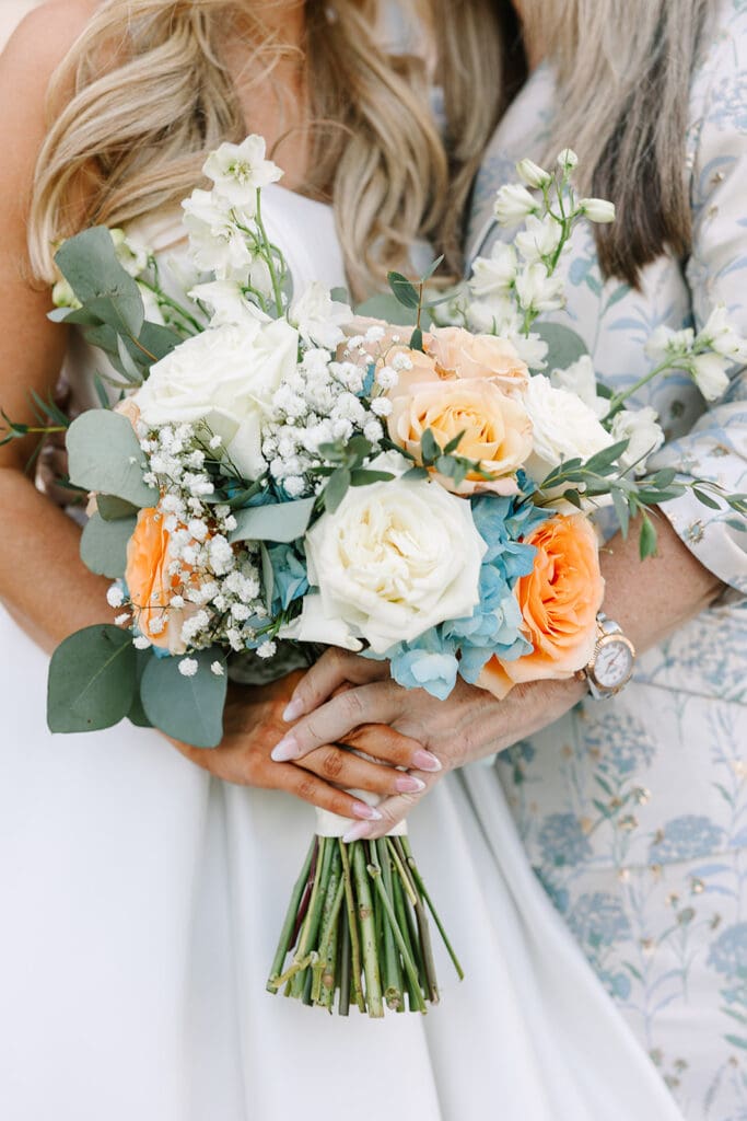 dusty blue and peach bridal bouquet at a wedding at The Howey Mansion captured by Jennifer Holly Photography