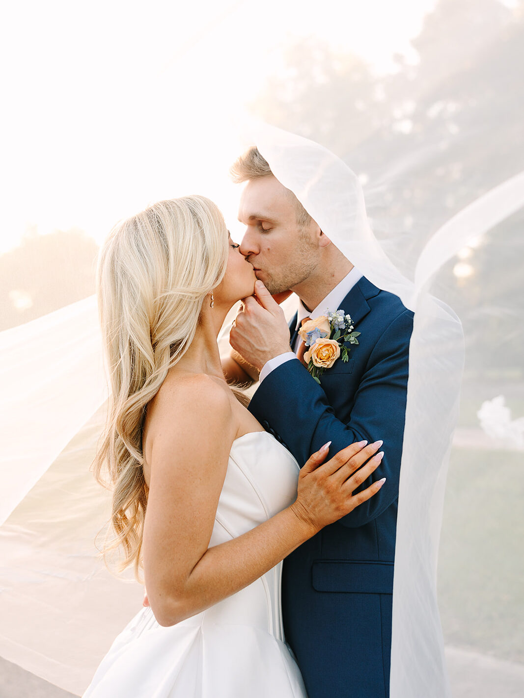 bride and groom outdoor wedding portrait under her veil at The Howey Mansion captured by Jennifer Holly Photography