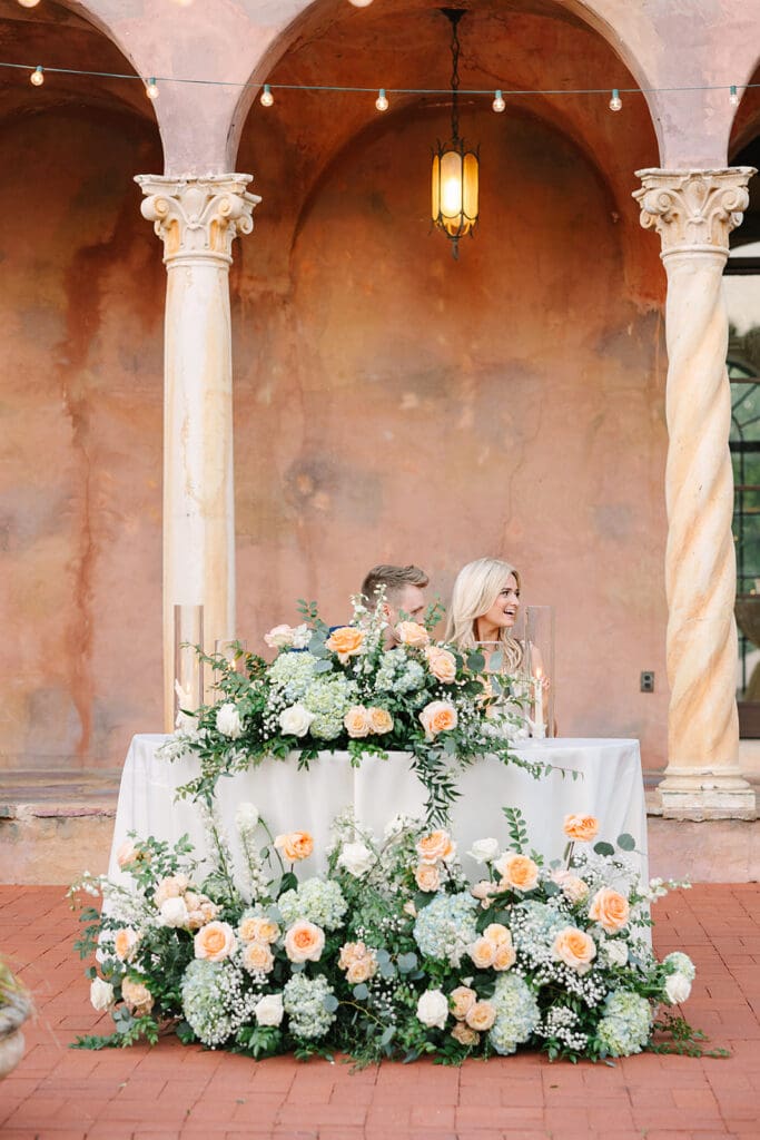 bride and groom sweetheart table at their outdoor wedding reception at The Howey Mansion captured by Jennifer Holly Photography