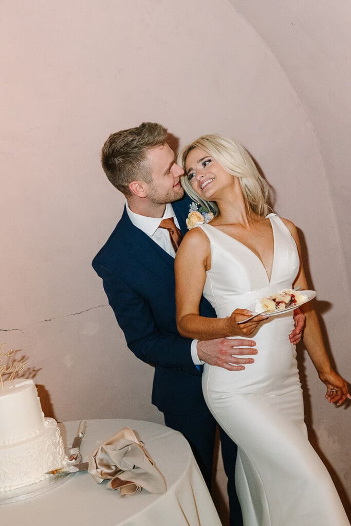 bride and groom cut their cake at a wedding reception at The Howey Mansion captured by Jennifer Holly Photography