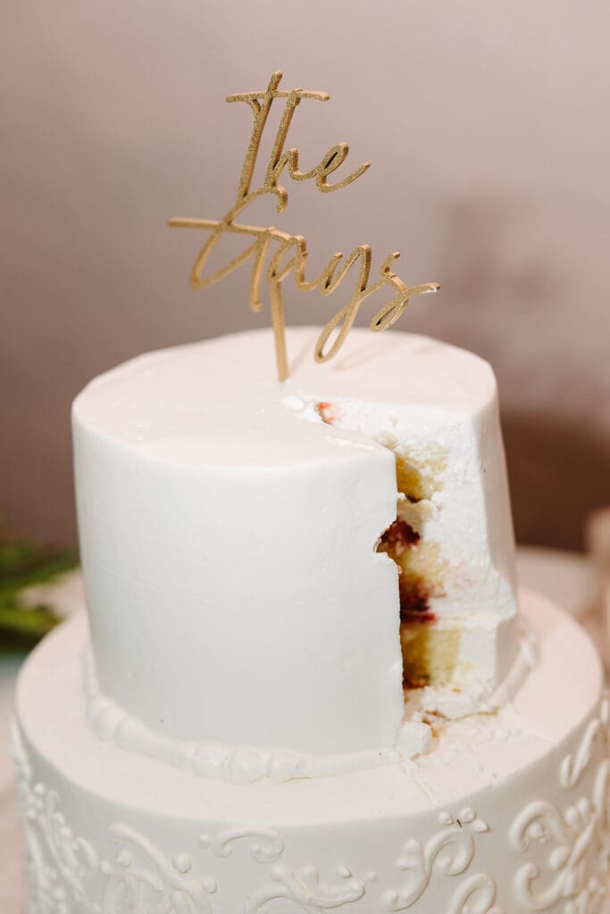 wedding cake with gold cake topper at The Howey Mansion captured by Jennifer Holly Photography