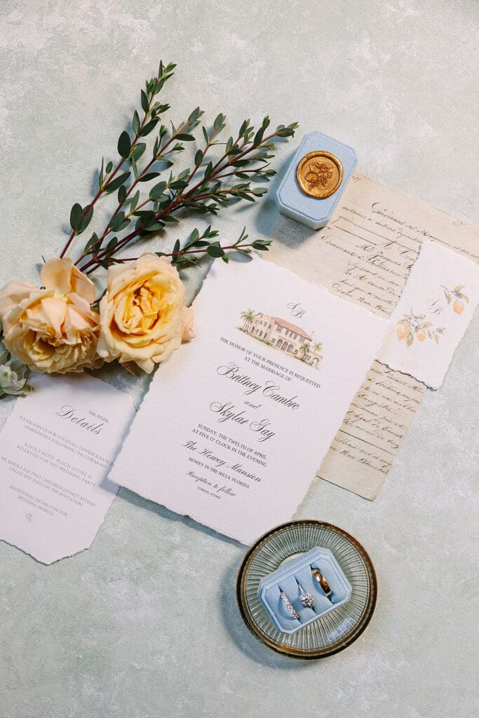 dusty blue and peach wedding details flat lay at a wedding at The Howey Mansion captured by Jennifer Holly Photography