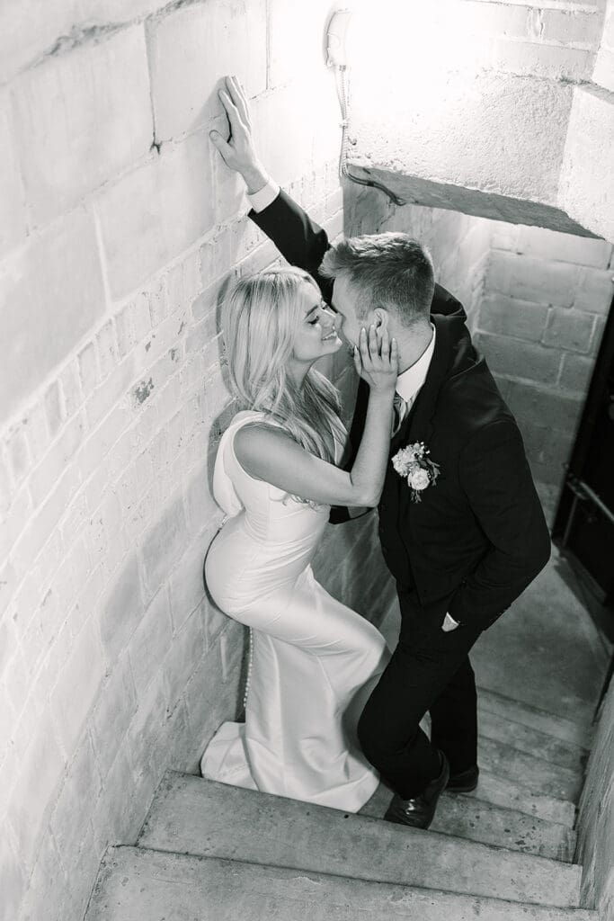 bride and groom in the stairway down to the Prohibition Vault at The Howey Mansion captured by Jennifer Holly Photography