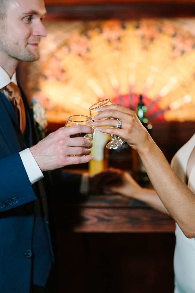 bride and groom cheers in the Prohibition Vault at The Howey Mansion captured by Jennifer Holly Photography