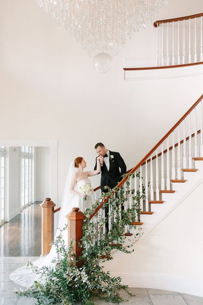 bride and groom portraits on the grande staircase at Florida mansion wedding venue, Luxmore Grande Estate, captured by Jennifer Holly Photography