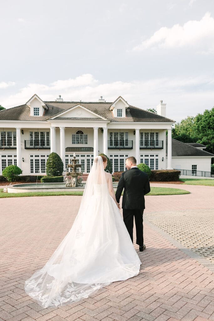 bride and groom portrait in front of their Florida mansion wedding venue, Luxmore Grande Estate, captured by Jennifer Holly Photography