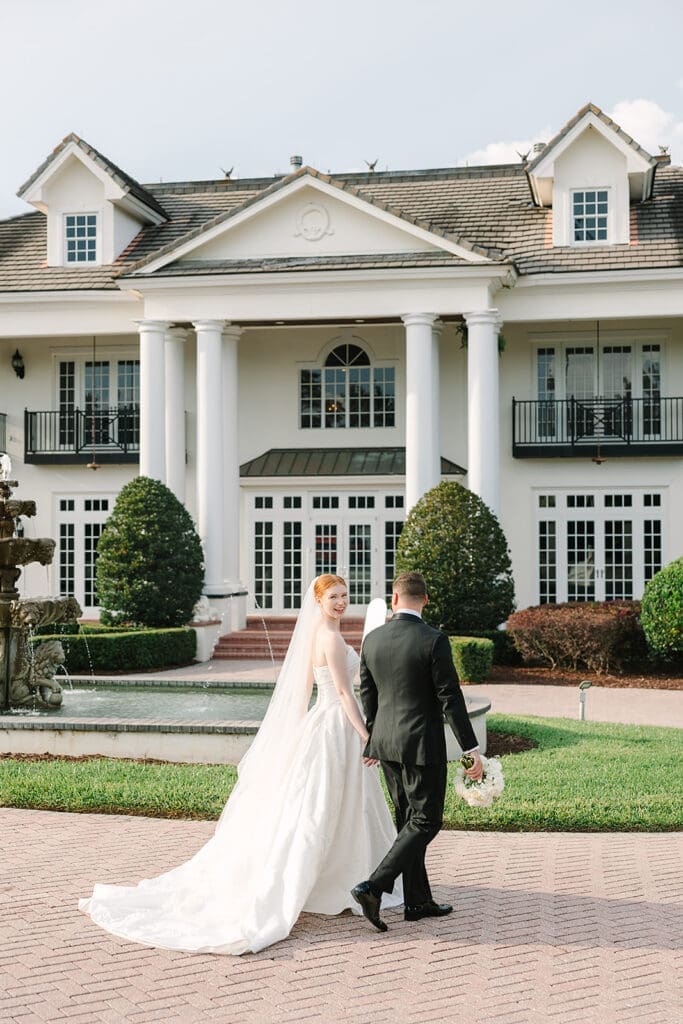 bride and groom portrait in front of their Florida mansion wedding venue, Luxmore Grande Estate, captured by Jennifer Holly Photography