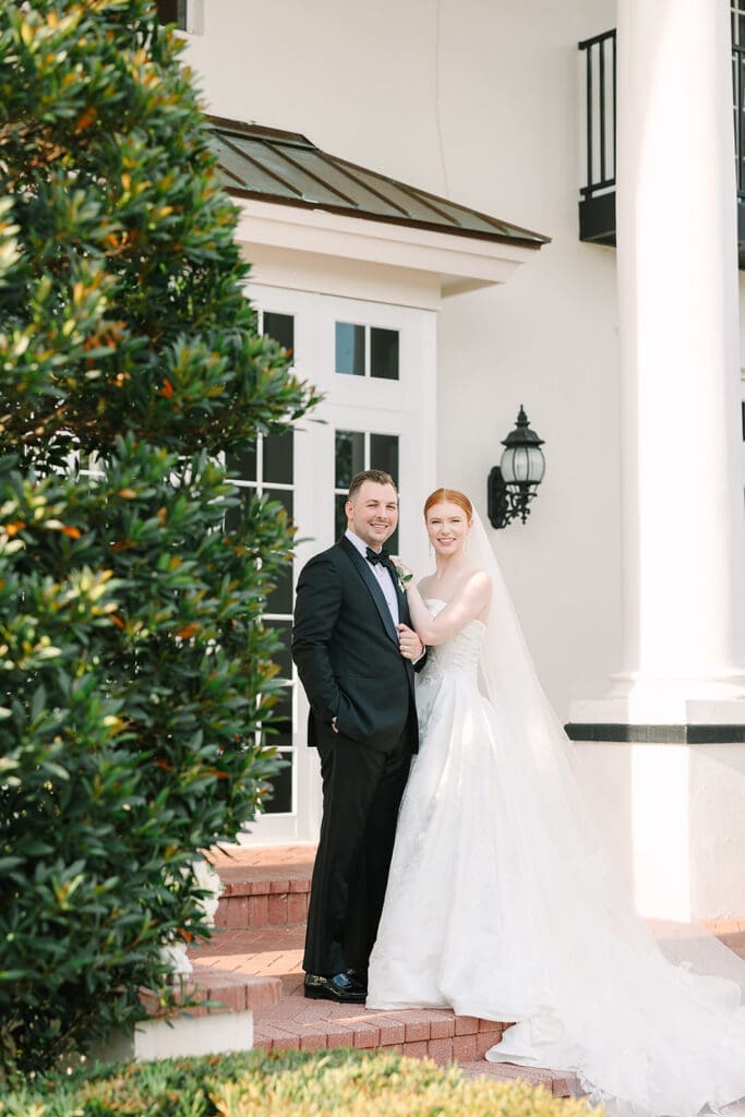 bride and groom portrait in front of their Florida mansion wedding venue, Luxmore Grande Estate, captured by Jennifer Holly Photography