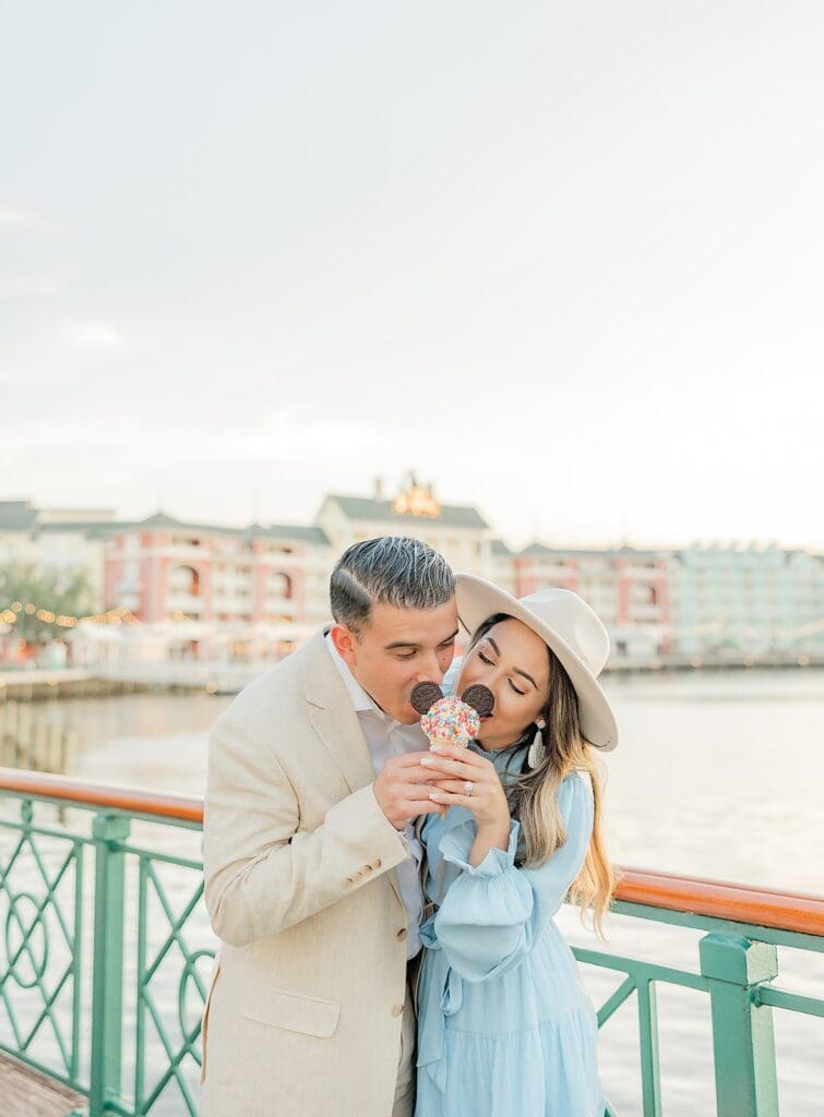 fun and candid couple portrait at Disney Boardwalk, holding a Mickey-shaped ice cream cone