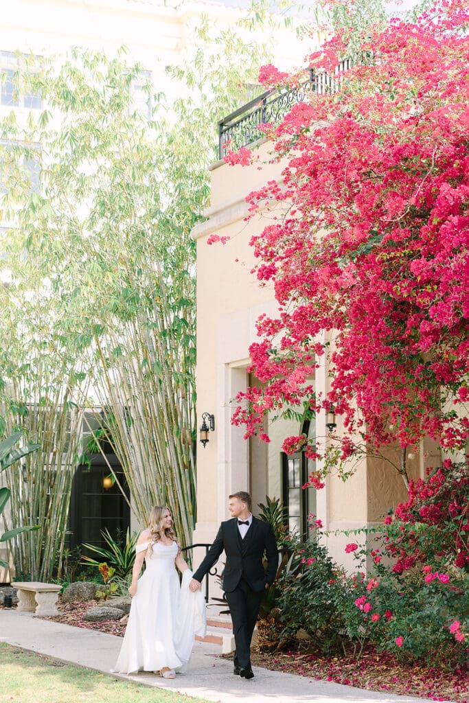 bride and groom walking at Rollins College in an elopement portrait captured by Jennifer Holly Photography, an Orlando elopement and wedding photographer