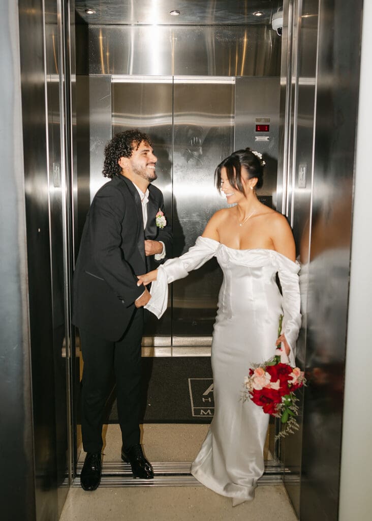 bride and groom candid in an elevator in downtown Orlando in an elopement portrait captured by Jennifer Holly Photography, an Orlando elopement and wedding photographer