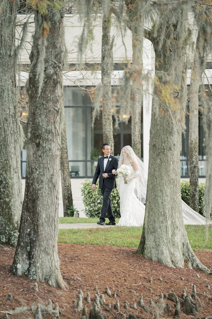 bride and her father walk into an outdoor wedding ceremony at Hyatt Regency Grand Cypress Resort in Orlando, Florida, captured by Jennifer Holly Photography