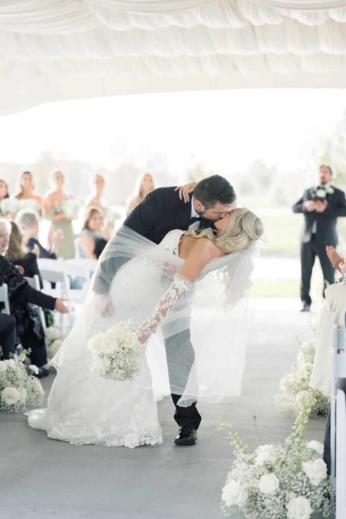 bride and groom kiss in an outdoor wedding ceremony at Hyatt Regency Grand Cypress Resort in Orlando, Florida, captured by Jennifer Holly Photography