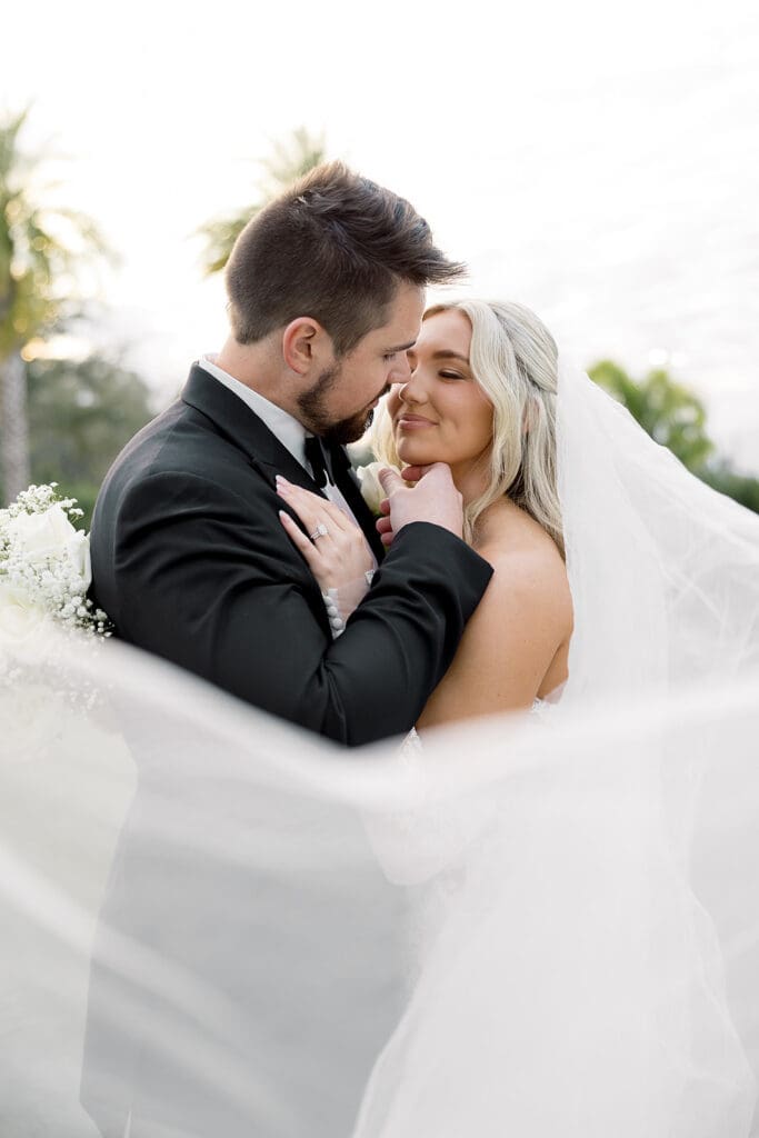 outdoor wedding bride and groom portrait under her veil at Hyatt Regency Grand Cypress Resort in Orlando, Florida, captured by Jennifer Holly Photography