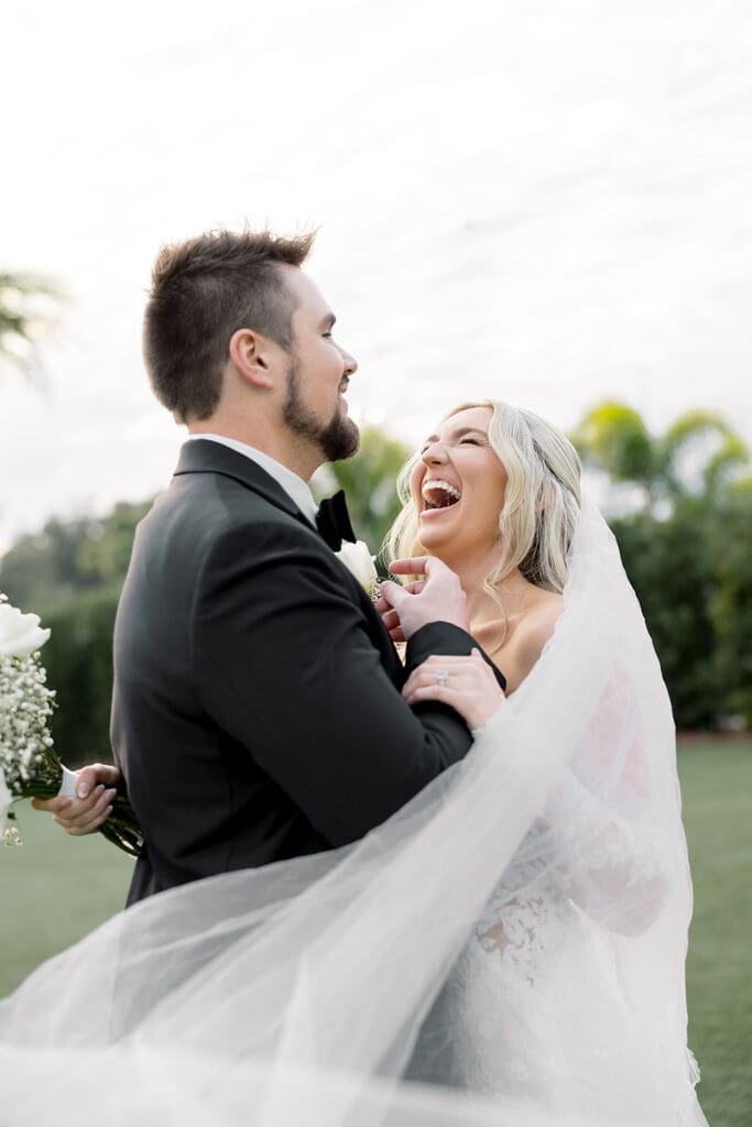 outdoor wedding bride and groom portrait under her veil at Hyatt Regency Grand Cypress Resort in Orlando, Florida, captured by Jennifer Holly Photography