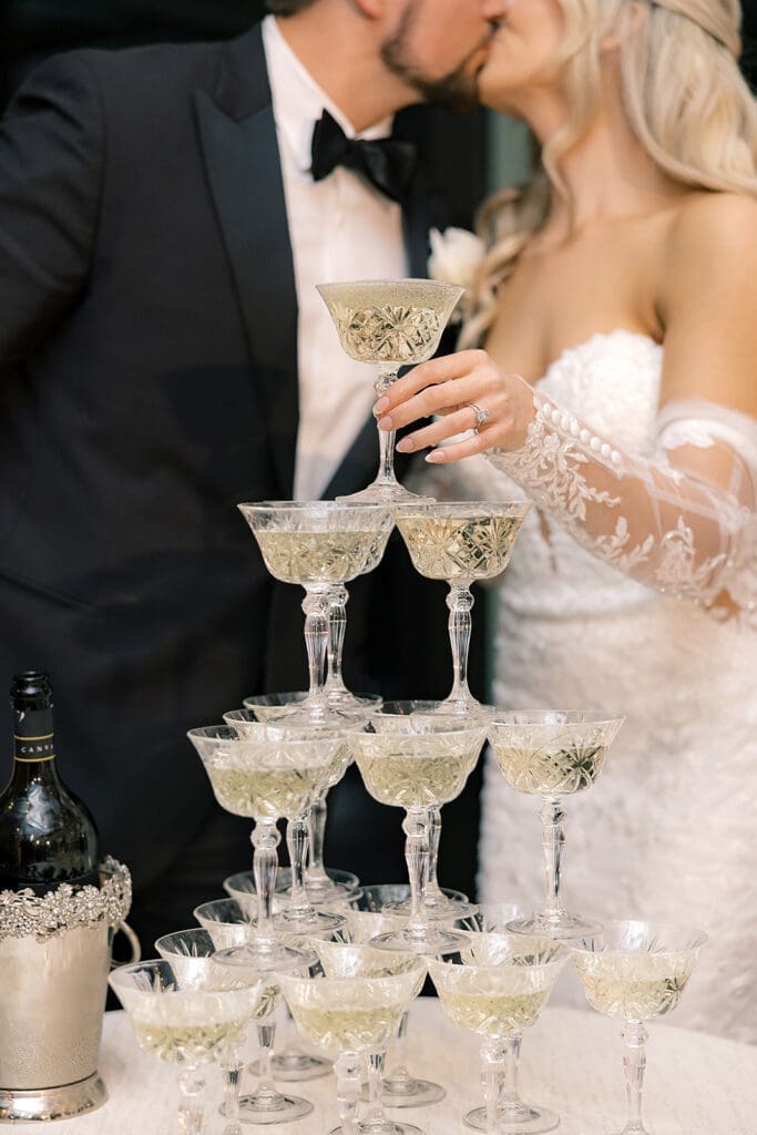 bride and groom pouring a champagne tower at a wedding reception at Hyatt Regency Grand Cypress Resort in Orlando, Florida, captured by Jennifer Holly Photography