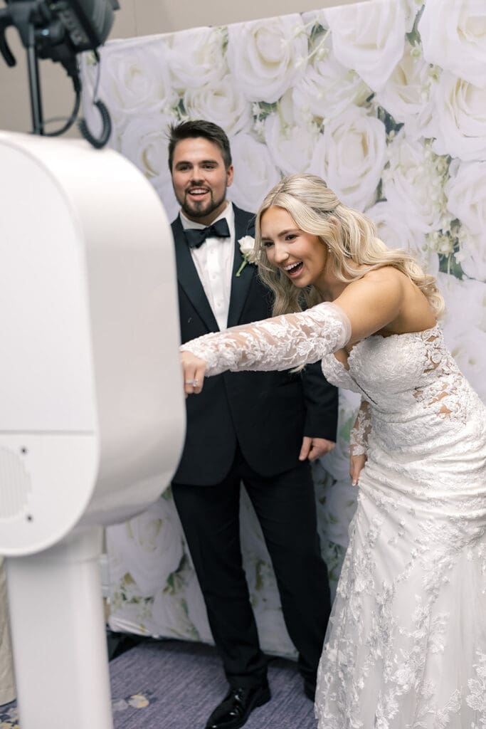 bride and groom at the photo booth at a wedding reception at Hyatt Regency Grand Cypress Resort in Orlando, Florida, captured by Jennifer Holly Photography