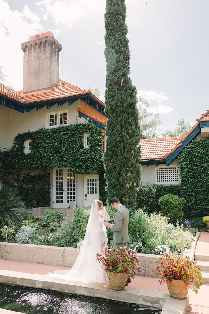 bride and groom stand share private vows in the garden at Sydonie Mansion in an elopement portrait captured by Jennifer Holly Photography, an Orlando elopement and wedding photographer